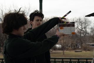 Second assistant camera holding the clapperboard for If I Could Touch the Sun up in front of the lens
