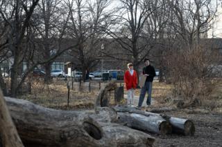 Wide of the two leads small among the trees and the fallen logs, the park emptying behind them