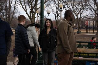 The company talking together beside the park lamppost at the end of the day