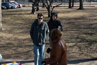 Script pages in hand as the scene is talked through with two of the company out on the open ground