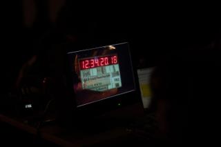 Monitor showing a clapperboard with running timecode during a take