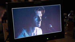 Camera monitor showing the actor lit in cool blue during a take