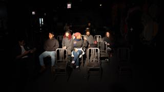 The company seated in the house between setups