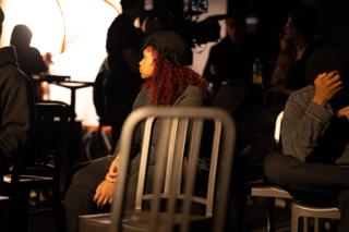 Crew member seated in the house, watching the stage over the backs of the chairs