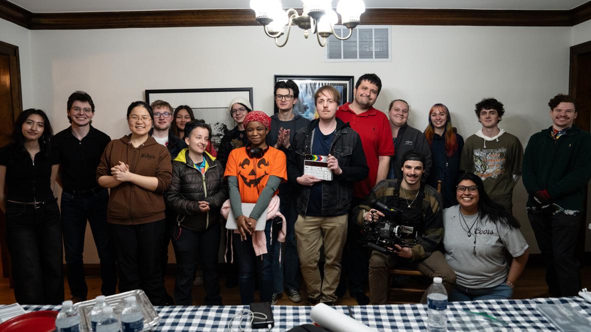 Cast and crew of If I Could Touch the Sun gathered on location, one holding a clapperboard and another a camera
